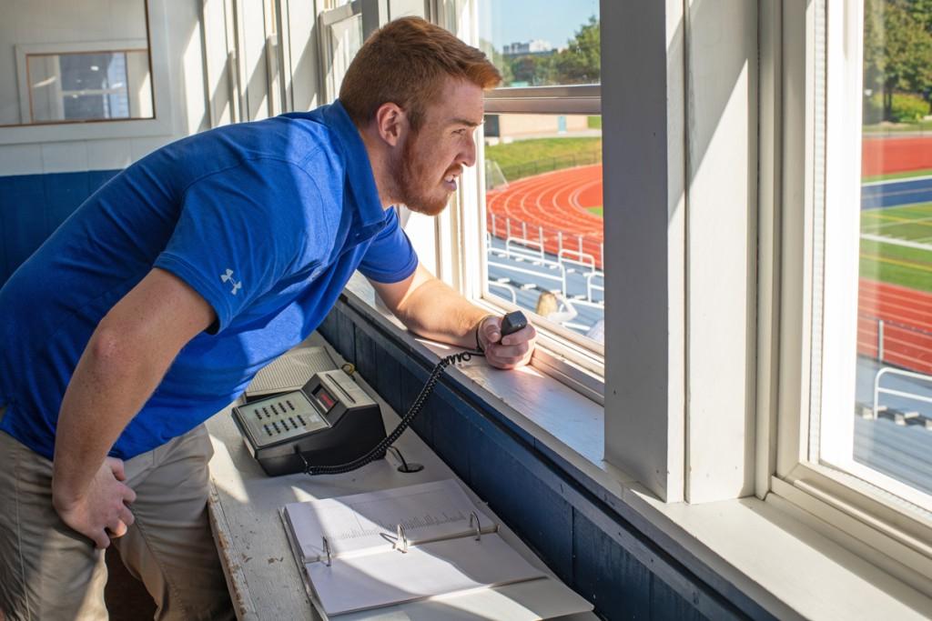 U N E student looks out over a track field