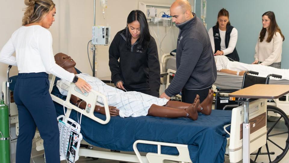 A group of physical therapy students in the simulation lab