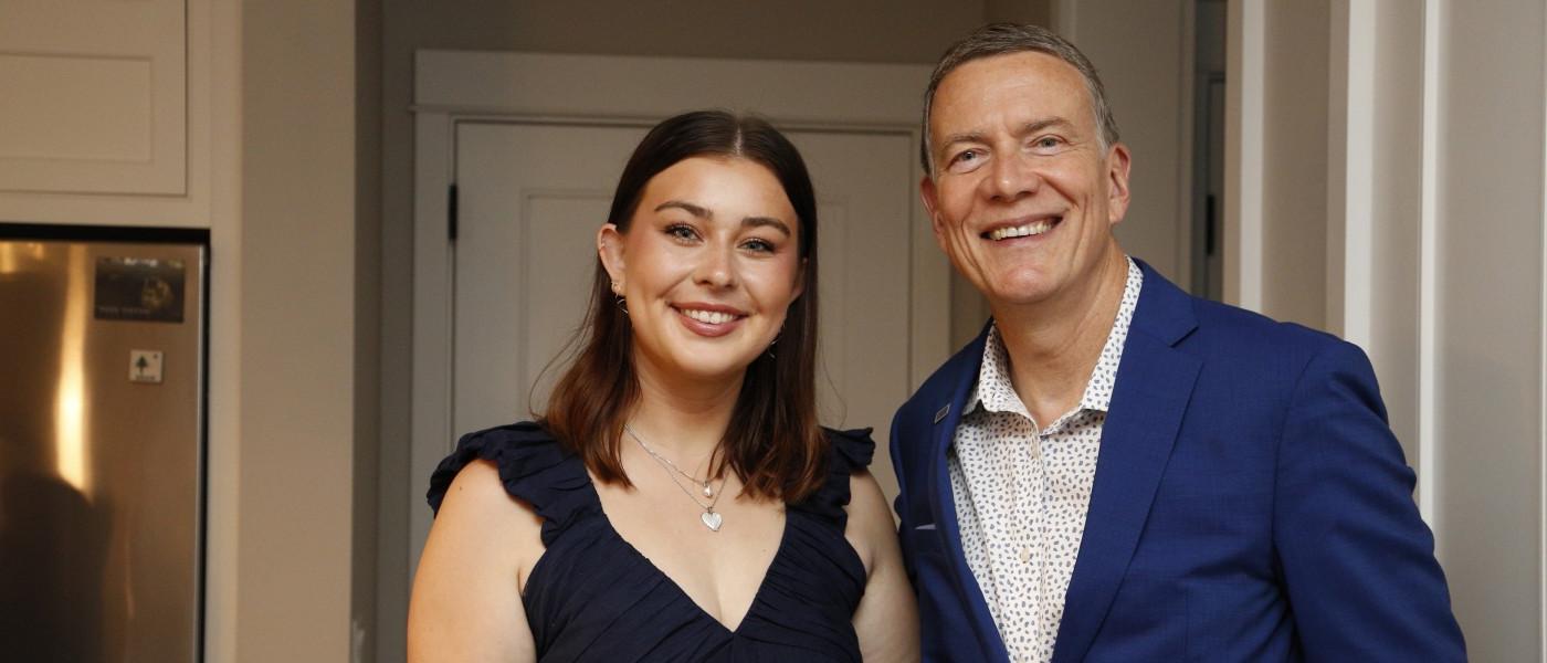 Abbie Anderson poses with UNE President James Herbert